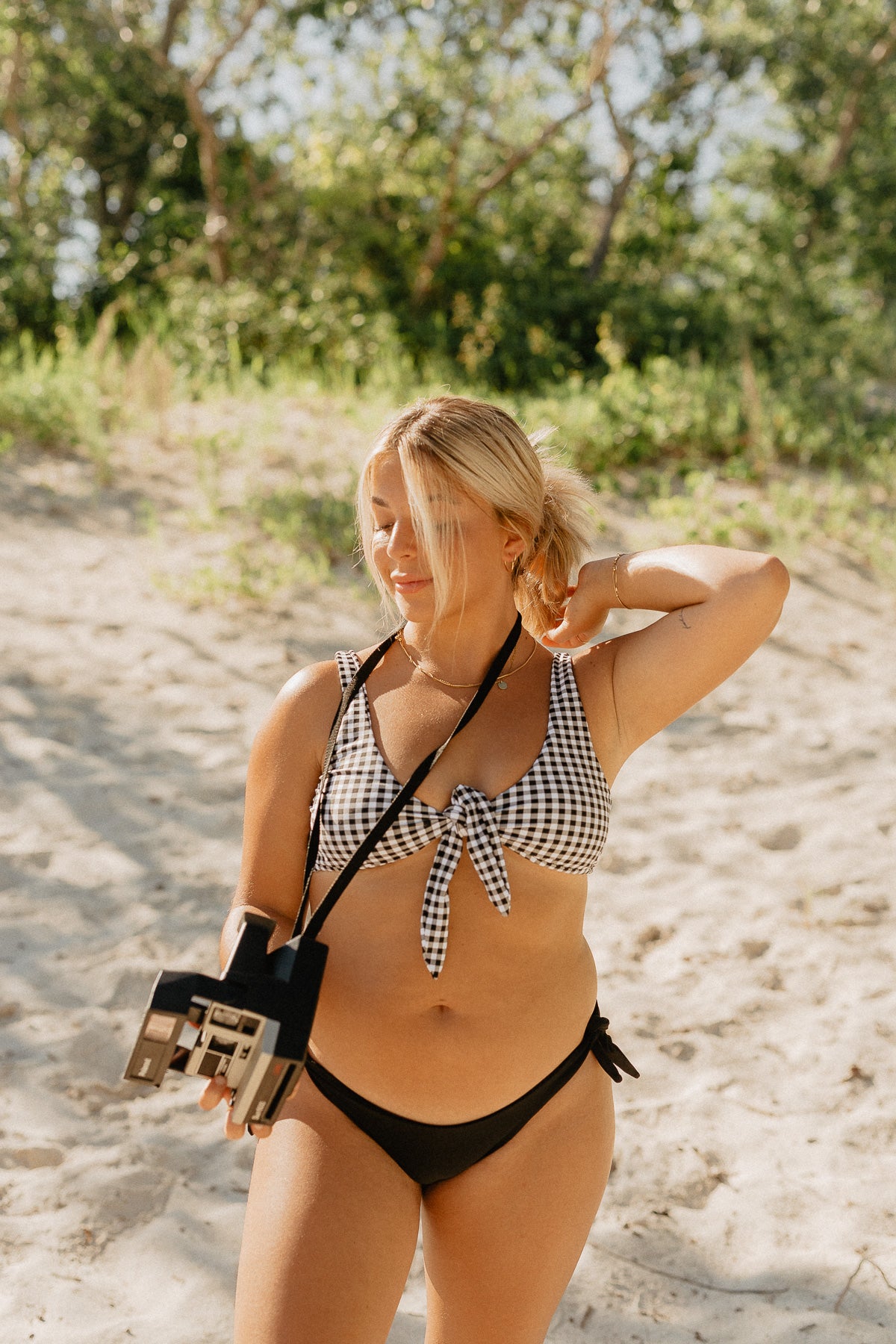 Influencer Nicole Zajac wears new Canadian swimsuit brand, Prairie Swim. Black adjustable tie-side cheeky coverage bikini bottoms. Mix and match.