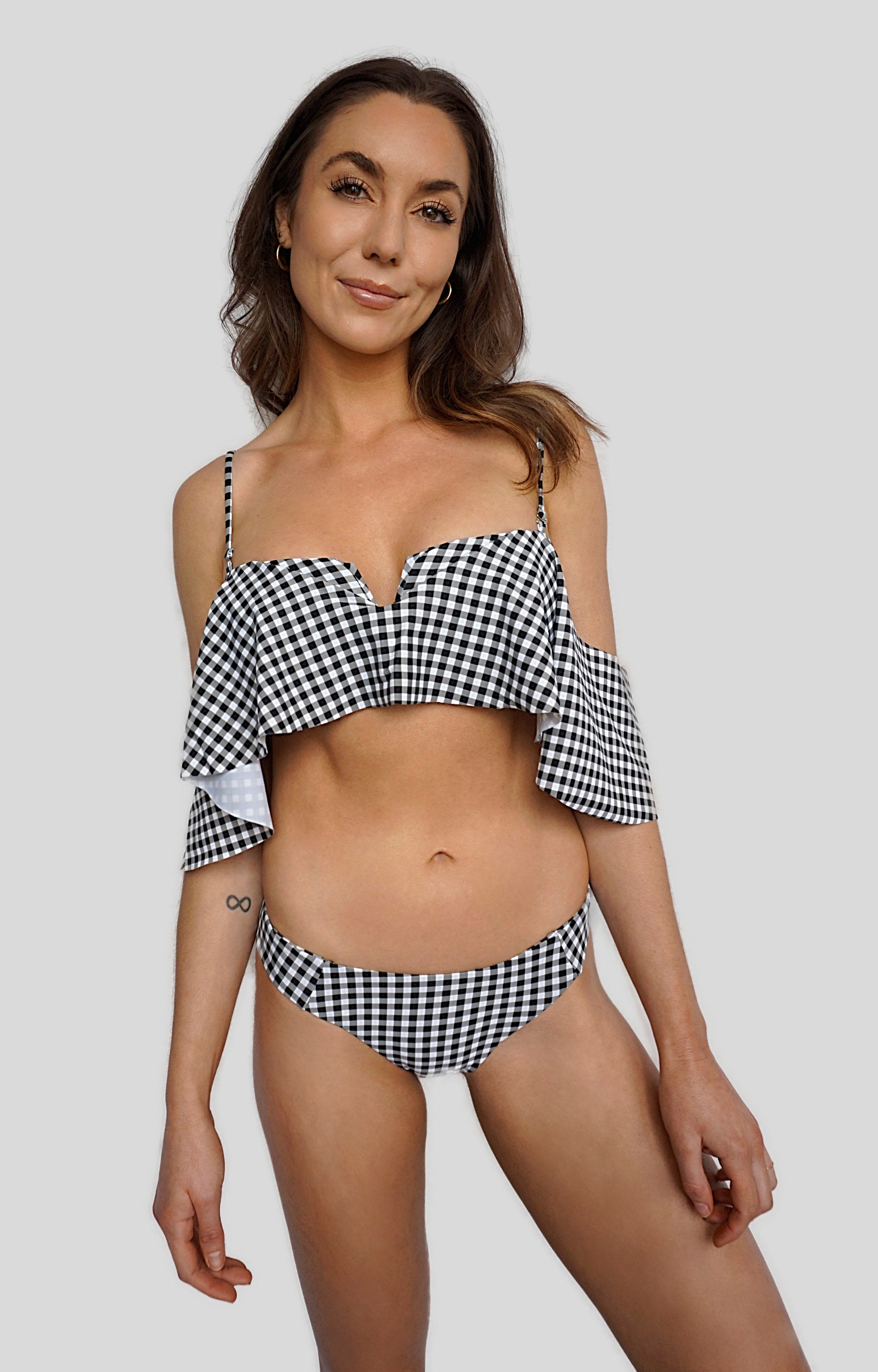 Carling Liski wears Canadian swimwear brand Prairie Swim black and white gingham ruffle off the shoulder bikini